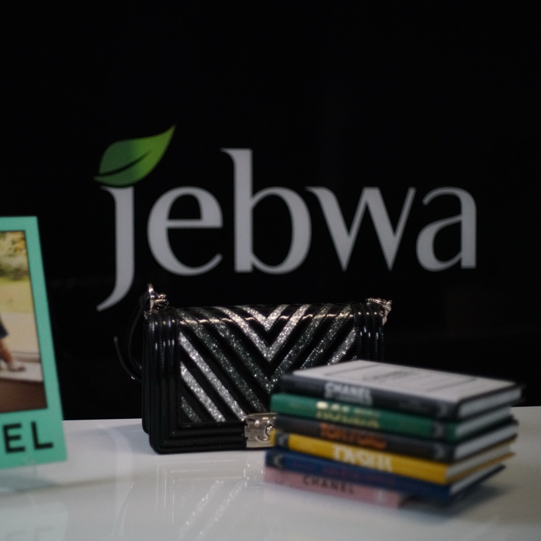 A luxury handbag and designer monographs styled at Jebwa